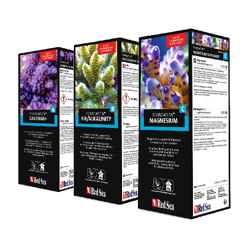 Marine aquarium supplements for calcium, alkalinity, and magnesium with coral images on boxes